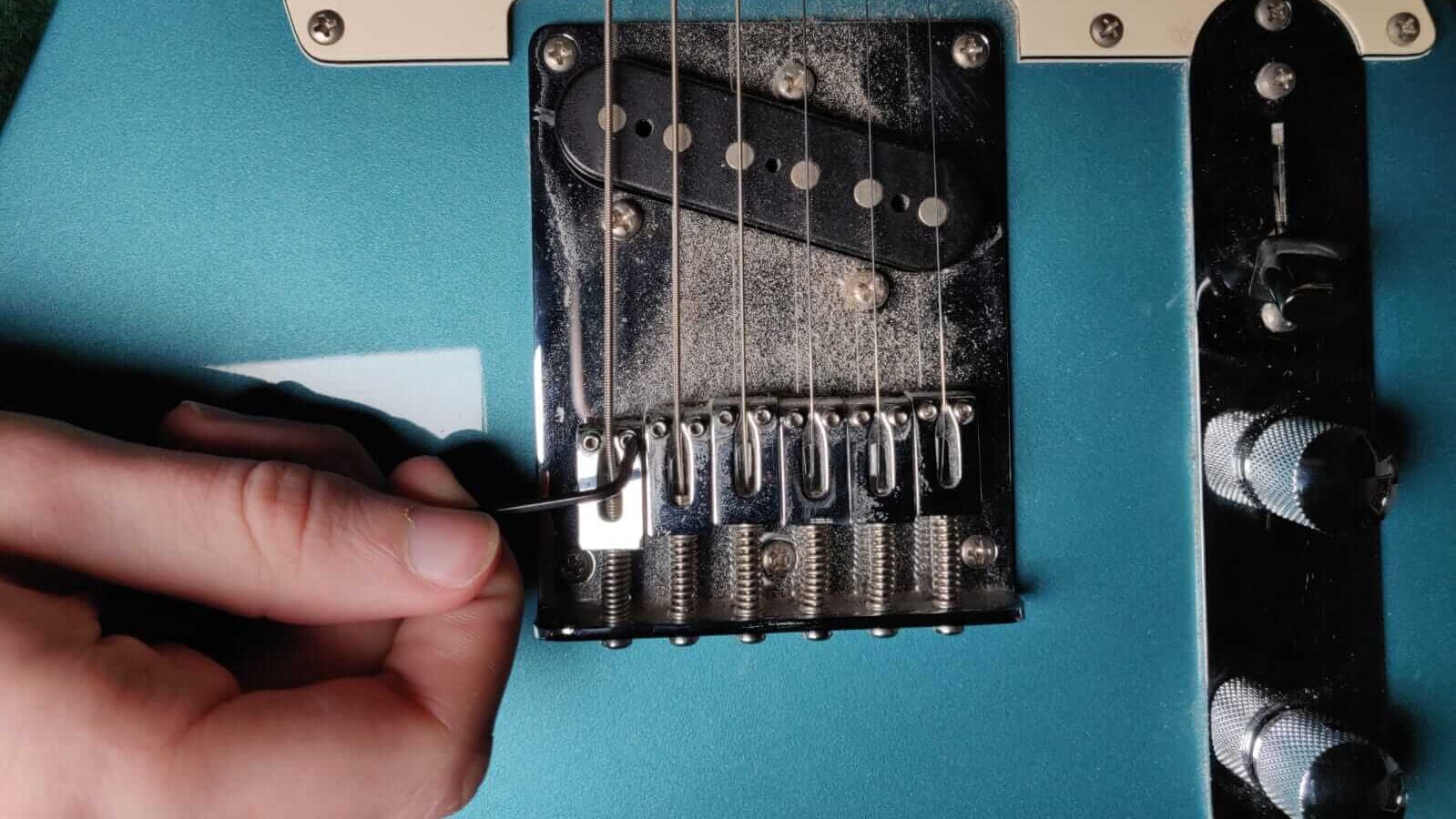 Guitar action screws adjustment